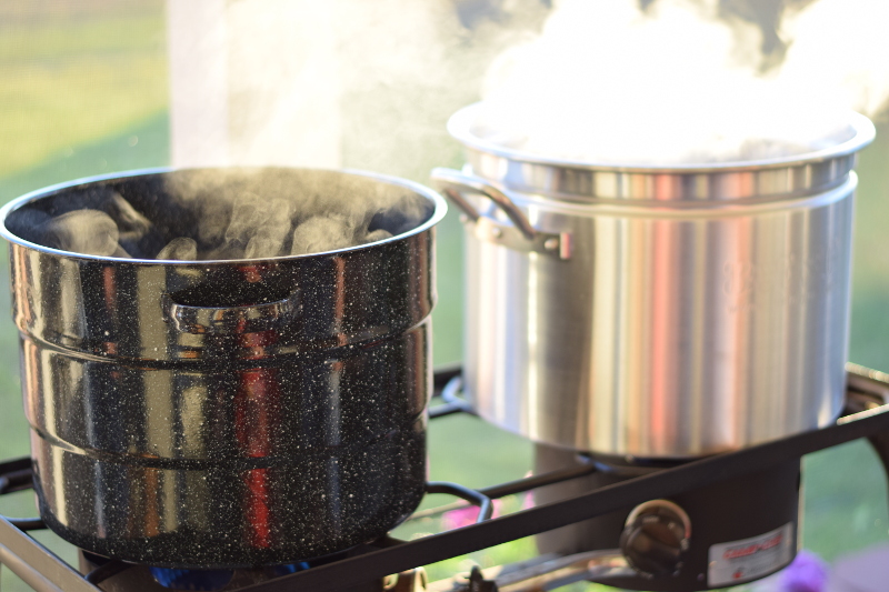 gas cooker cooking seafood in two big pots