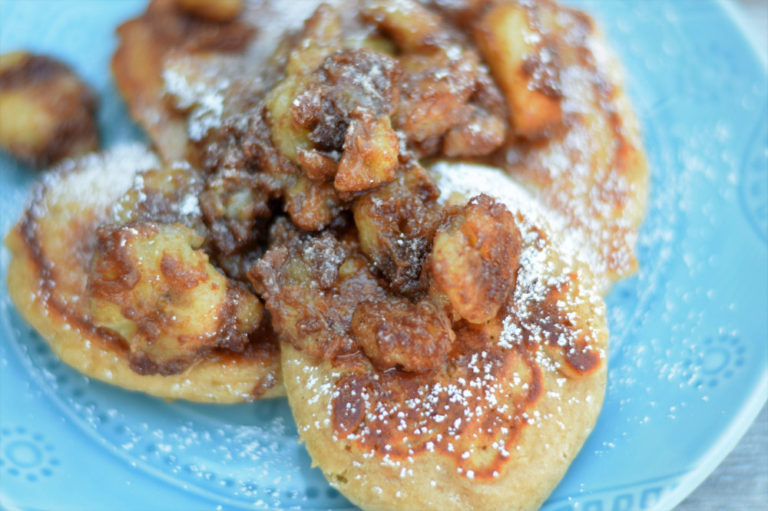 banana pancakes covered in powdered sugar