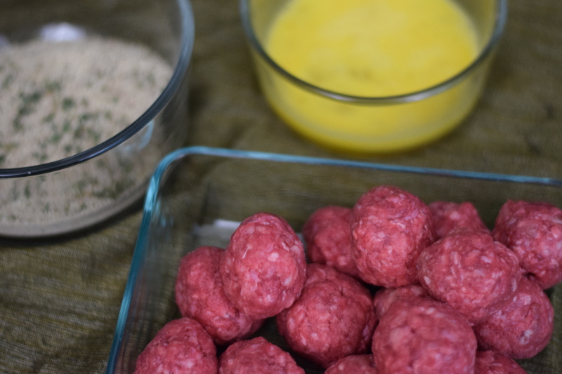raw meatballs and egg wash for meatball submarine recipe