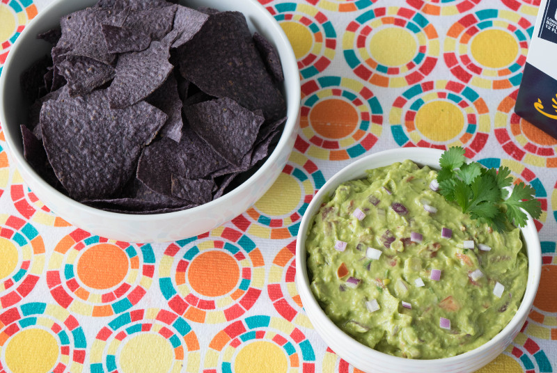 blue tortilla chips and guacamole
