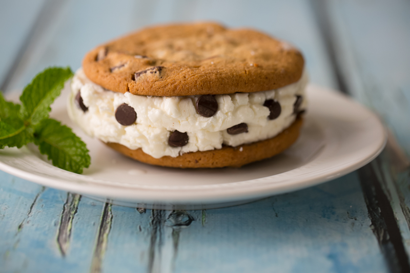 mint chocolate chip ice cream sandwiched between two chocolate chunk cookies