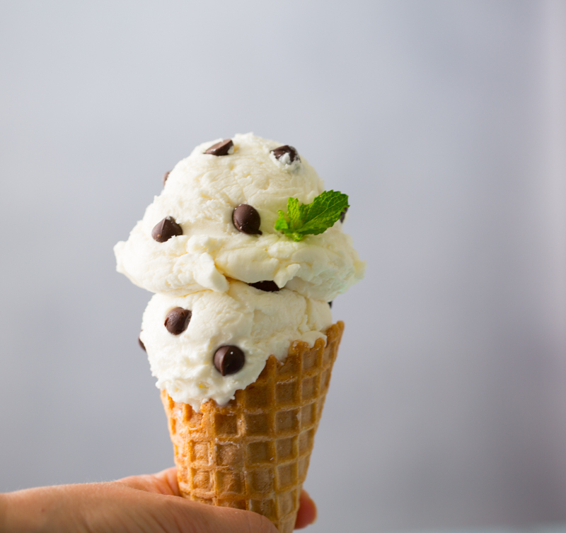 mint chocolate chip ice cream in a waffle cone