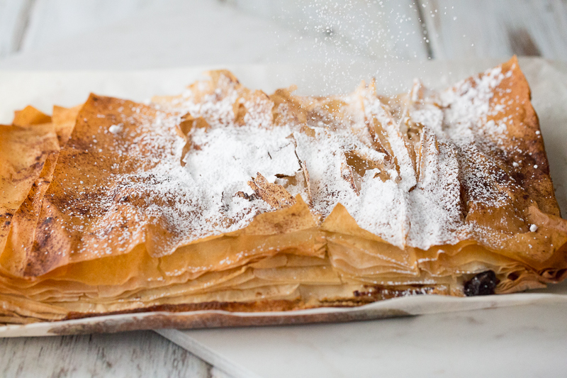 dusting very berry phyllo bars with powdered sugar