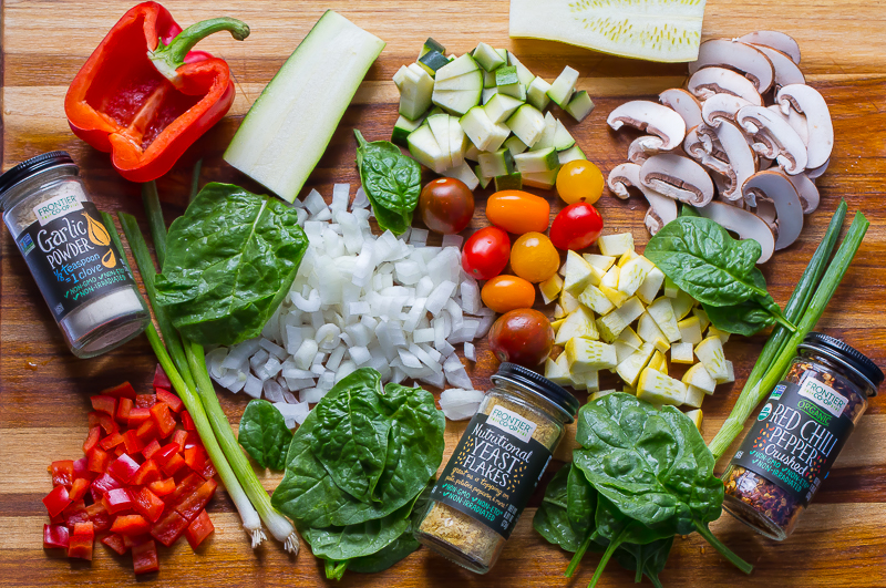 Fresh produce and spices on teak cutting board