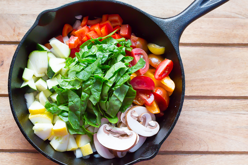 raw veggies in cast iron skillet