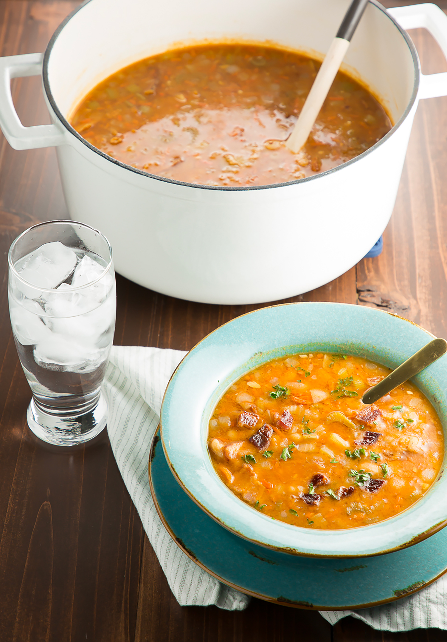 Bowl of Bean and Bacon Soup and a glass of water.