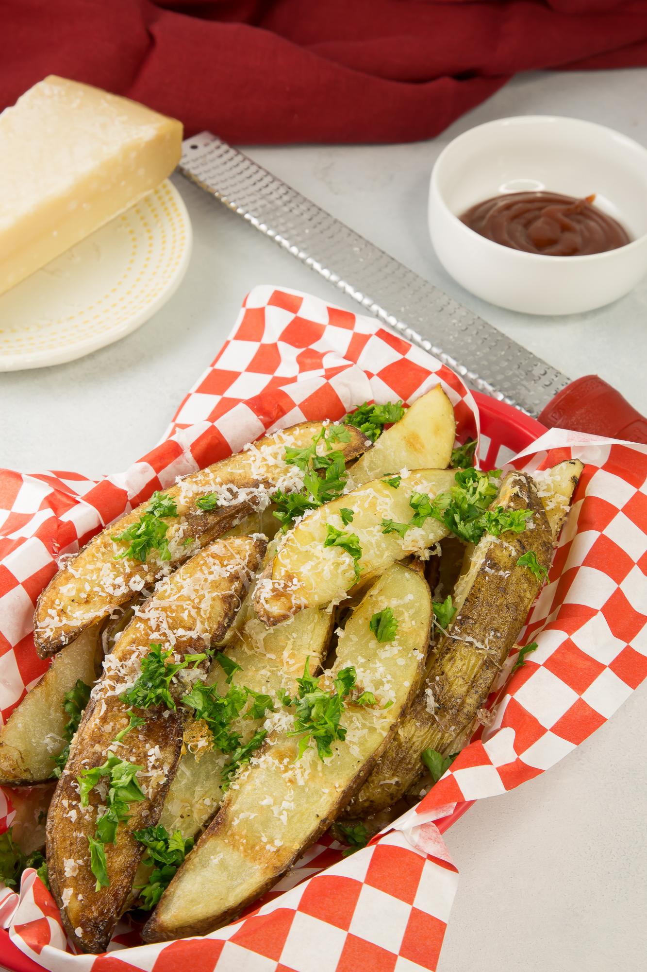 Broasted potato wedges in a basket with ketchup