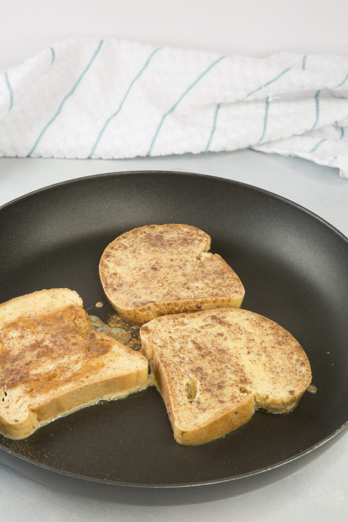 french toast pieces cooking in a pan