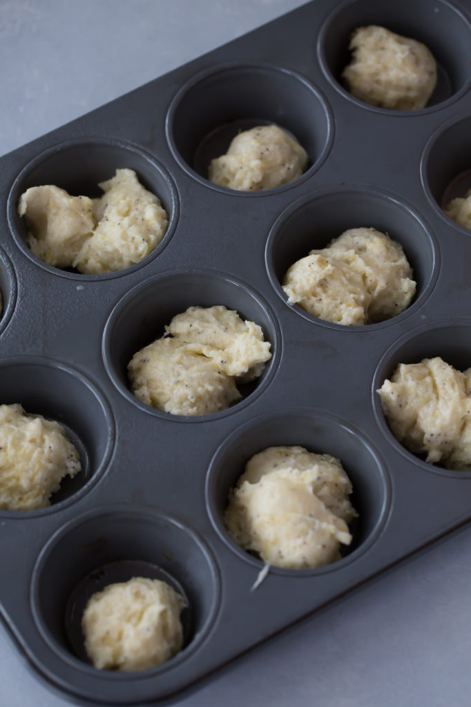 lemon poppy seed muffins in a muffin tin
