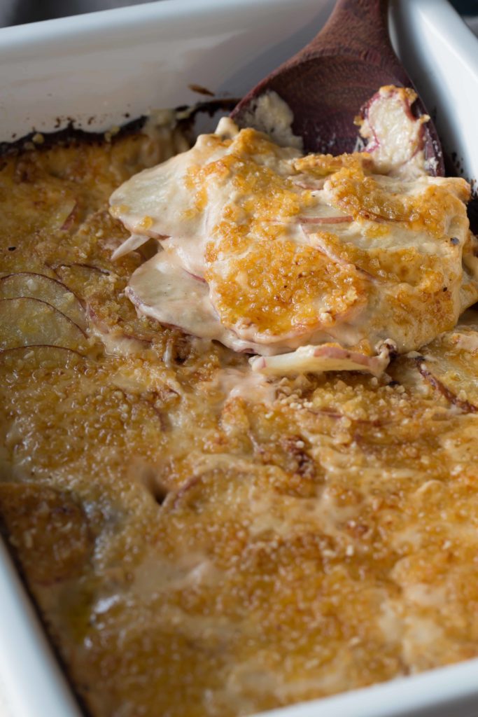 cheesy scalloped potatoes in a baking dish