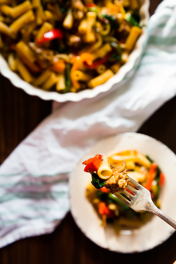 a bite of rigatoni with sausage and peppers