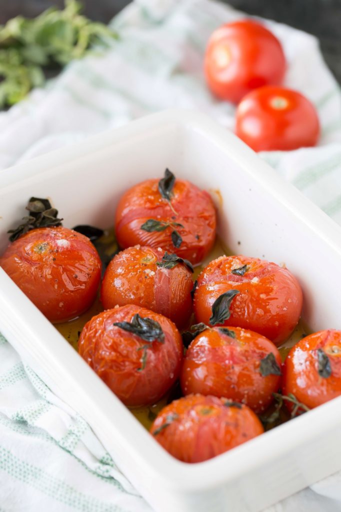 broiled tomatoes with fresh oregano in baking dish