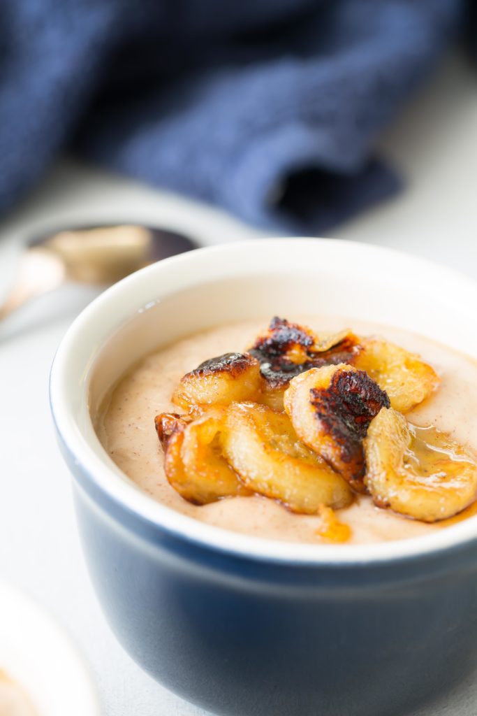 honey and cinnamon pudding with caramelized bananas in a ramekin